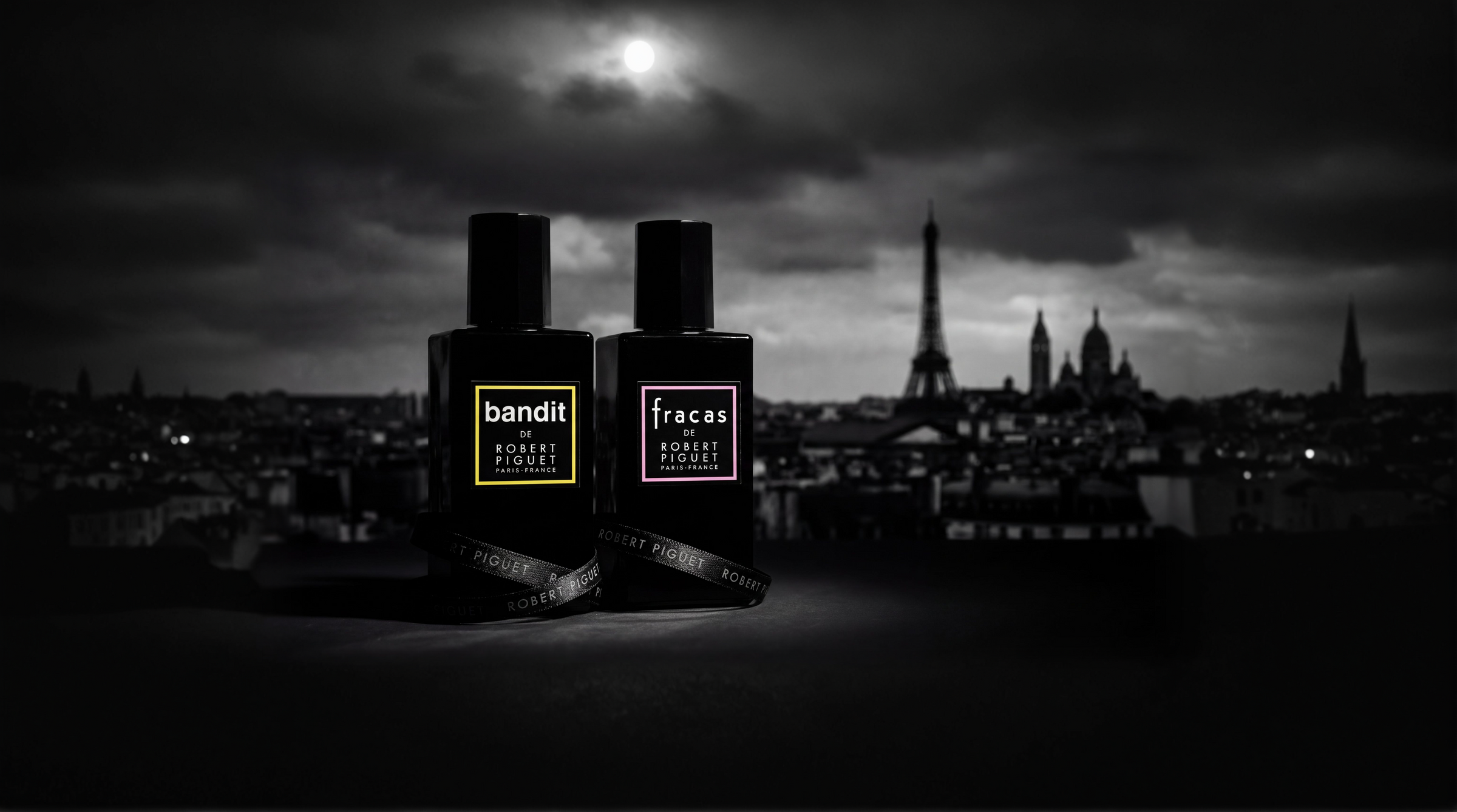 Bandit and Fracas perfume bottles with a black and white Parisian skyline backdrop
